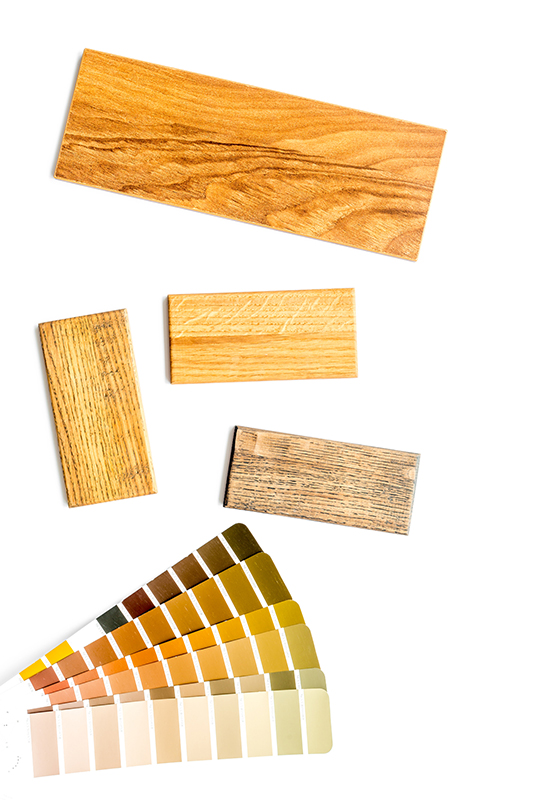wood samples stained in different coloured lacquer finishes