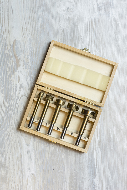 wooden case with drill bits displayed inside