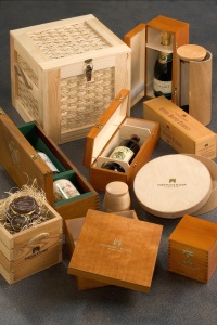 A collection of luxurious wooden wine  and food boxes of various shapes and sizes displayed on a dark surface, exuding elegance and sophistication.