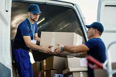 couriers loading a van with boxes