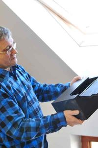 man inspecting a wooden box for quality assurance