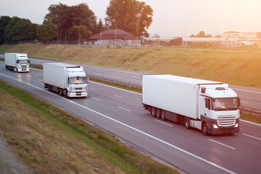 3 white  lorries on a motorway