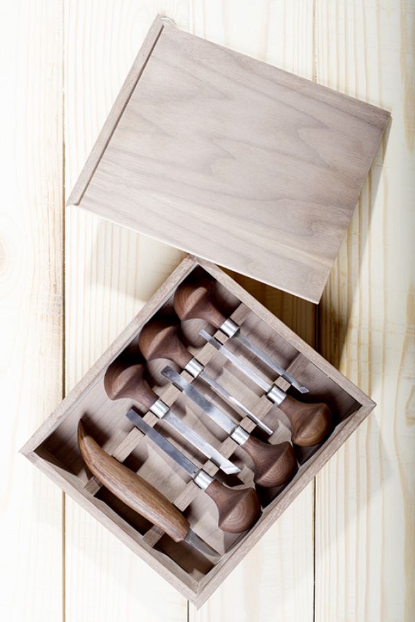 a wooden box with wood carving tools inside