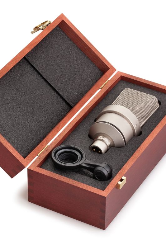 A wooden box opened on a table showing a Microphone head in a foam insert