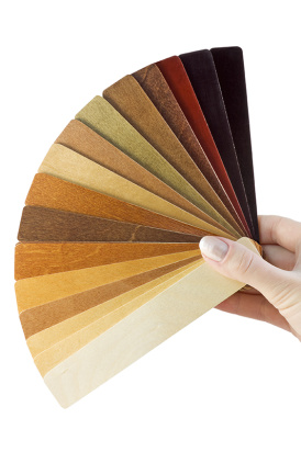 a hand holding a colour chart of wood stains